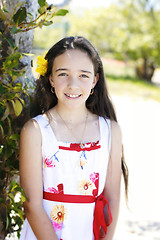 Image showing Portrait of a pretty, dark haired young girl outdoors.