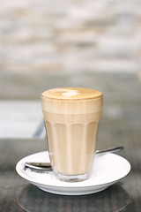 Image showing Latte in a glass on a café table.