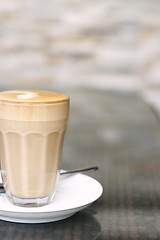 Image showing Latte in a glass on a café table.