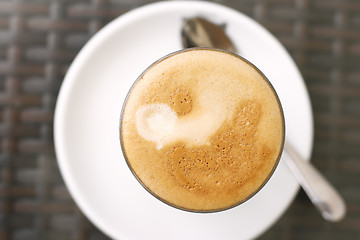 Image showing Top down view of a latte in a glass.