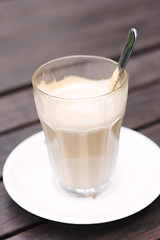 Image showing Half empty latte in a glass on a café table.