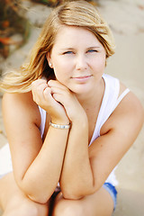 Image showing Portrait of a happy beautiful young blonde woman at the beach.