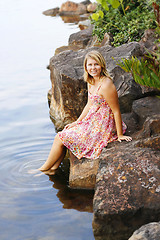 Image showing Beautiful young blonde woman at the water’s edge.