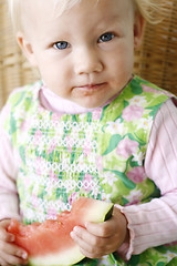 Image showing Cute little girl eating a watermelon.