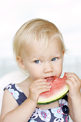 Image showing Cute little girl eating a watermelon.