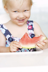 Image showing Cute little girl eating a watermelon.