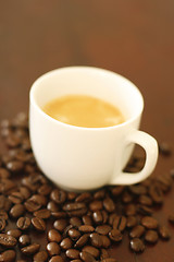 Image showing Espresso in cup surrounded by coffee beans.