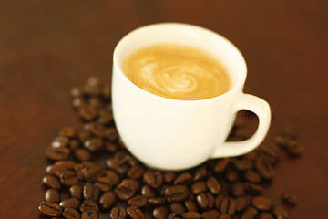 Image showing Espresso in cup surrounded by coffee beans.