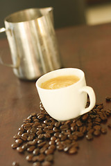 Image showing Espresso in cup surrounded by coffee beans.