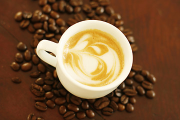 Image showing Top view of piccolo latte with a coffee art design.