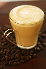 Image showing Delicious latte in glass with coffee art swirl design.