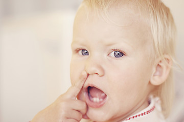 Image showing Cute little girl pointing at her nose.