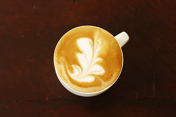 Image showing Top view of piccolo latte with a coffee art design.