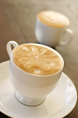 Image showing Delicious latte with coffee art design.