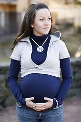 Image showing Happy young pregnant woman outdoors.