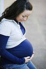 Image showing Young pregnant woman outdoors.