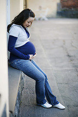 Image showing Young pregnant woman outdoors.