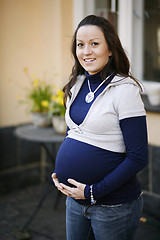 Image showing Happy young pregnant woman outdoors.