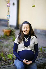 Image showing Happy young pregnant woman outdoors.