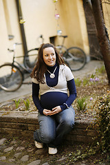 Image showing Happy young pregnant woman outdoors.