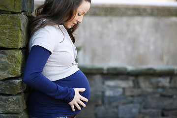 Image showing Young pregnant woman outdoors.