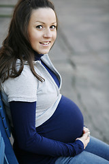 Image showing Happy young pregnant woman outdoors.