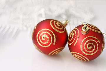Image showing Red Christmas baubles on a glass table.
