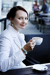 Image showing Beautiful business woman with a cappuccino in her hand.