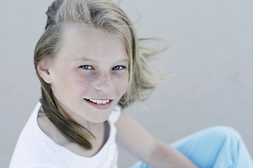 Image showing Close-up portrait of a pretty, blonde haired teenage girl outdoo