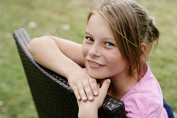 Image showing Close-up portrait of a pretty, blonde haired teenage girl outdoo