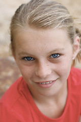 Image showing Close-up portrait of a pretty, blonde haired teenage girl outdoo