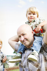 Image showing Happy father and two sons outdoors.