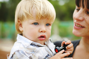 Image showing Happy mother and son outdoors.