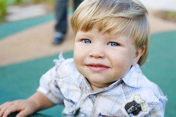 Image showing A happy little boy at a play park looking at the camera.
