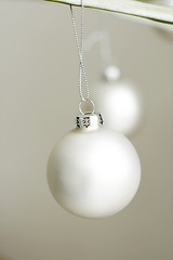 Image showing Two white decorative Christmas baubles.