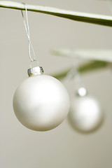 Image showing Two white decorative Christmas baubles.