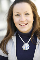 Image showing Portrait of a young happy and contented woman outdoors.