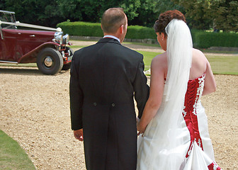 Image showing Back of Bride and Groom Walking