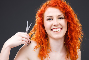 Image showing redhead with scissors