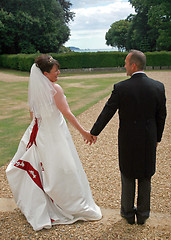 Image showing Back of Bride and Groom Holding Hands