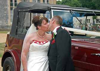 Image showing Kissing in front of Wedding Car