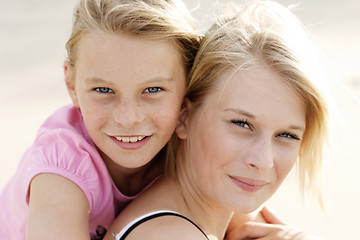 Image showing Two happy young sisters together outdoors.
