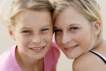 Image showing Two happy young sisters together outdoors.