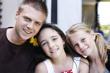 Image showing Portrait of three happy adolescents together outdoors.