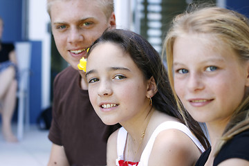 Image showing Portrait of three happy adolescents together outdoors.