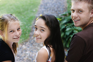 Image showing Portrait of three happy adolescents together outdoors