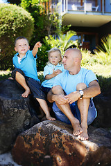 Image showing Father and sons together outdoors.