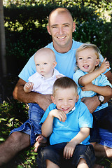 Image showing Father and sons together outdoors.