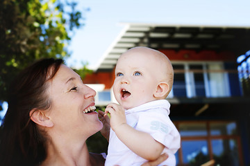 Image showing Close-up portrait of a mother and son outdoors.