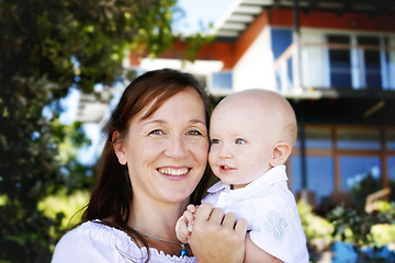 Image showing Close-up portrait of a mother and son outdoors.